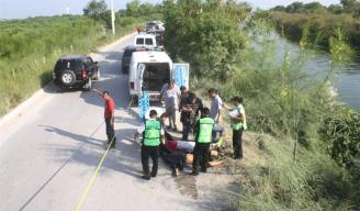 TARDE FATAL. Los cuerpos de los jóvenes futbolistas yacen a la orilla del canal Rodhe, donde perecieron ahogados al caer junto con la camioneta que tripulaban.