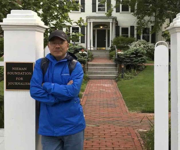 Familia: Periodista chino enfrenta cargos por espionaje