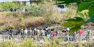 Migrantes se abalanzan contra Guardia Nacional de EU para cruzar al lado americano